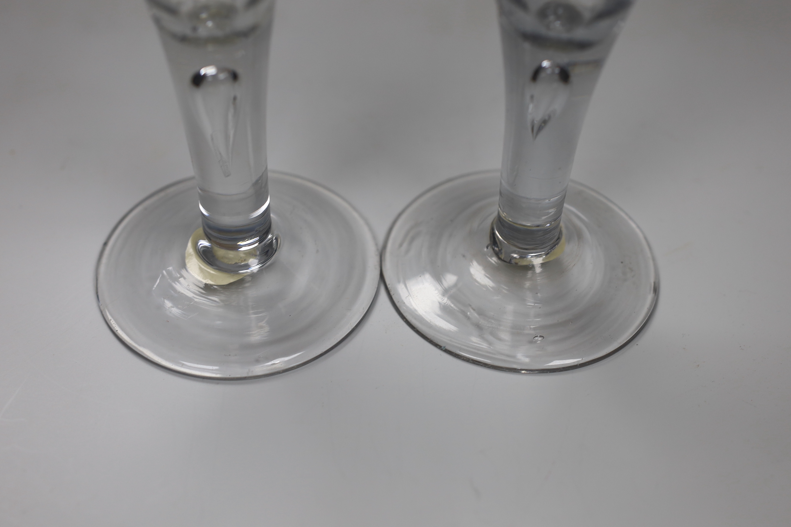 Two George II drawn trumpet wine glasses, each with air-tear, tallest 16cm